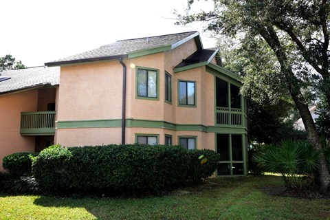 A two-story house with a balcony on the second floor.