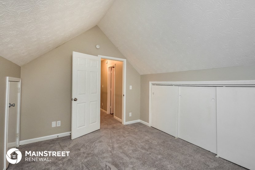 the upstairs bedroom of this home has a closet and a door to the hallway