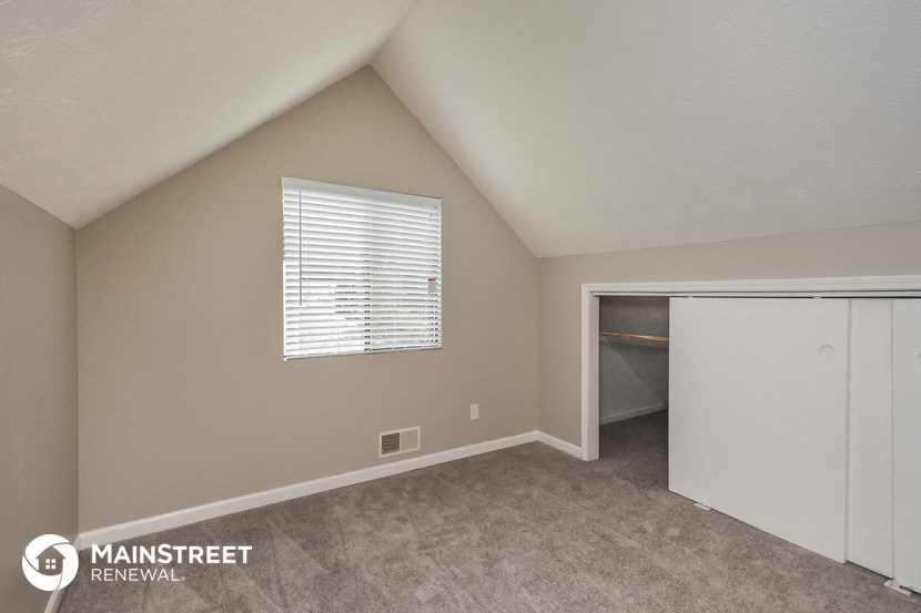 the upstairs bedroom has a closet and a door to the laundry room