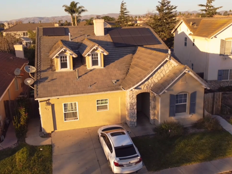 A house with a car parked in front.