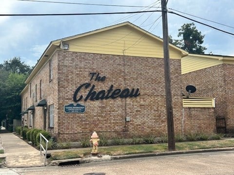 A brick building with a sign that says "The Chateau".