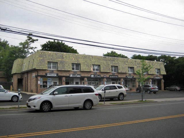 a building on the side of a street with cars