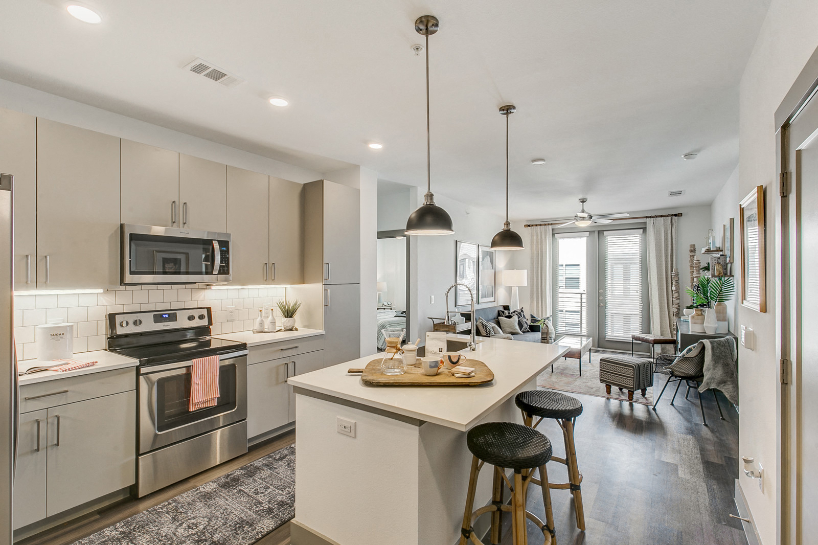a kitchen with stainless steel appliances and an island with stools