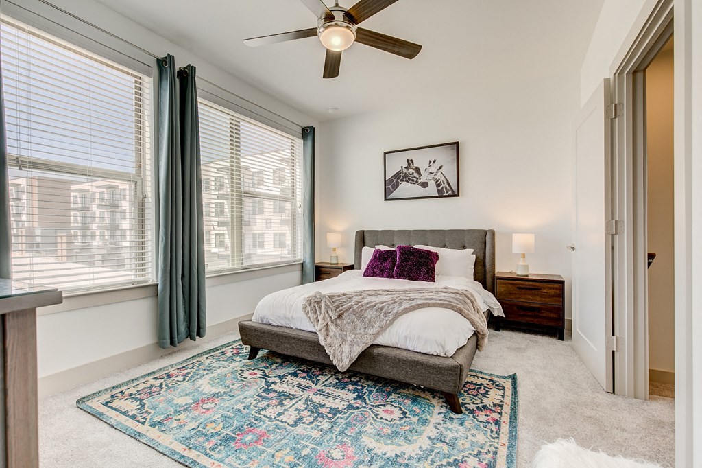a bedroom with a bed and a ceiling fan
