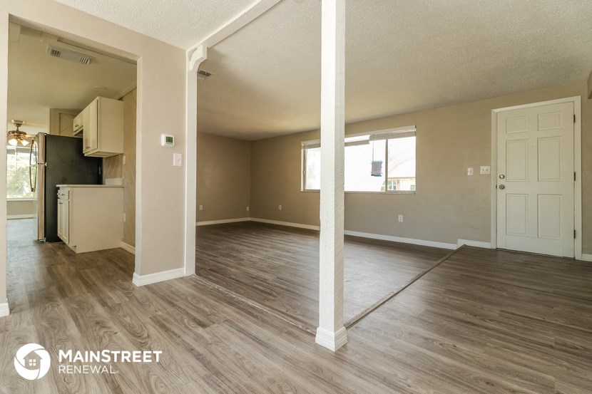 the living room and kitchen of an open floor plan