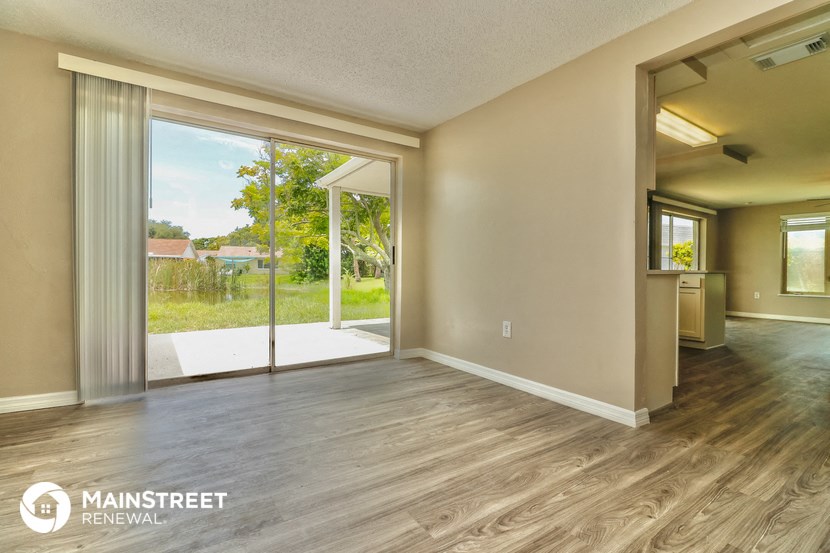 a living room with a sliding glass door to a patio