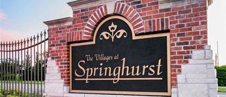 a sign for the village of springhurst on a brick wall