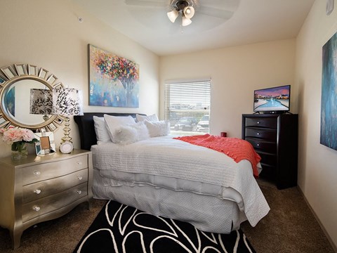 a bedroom with a bed and a window