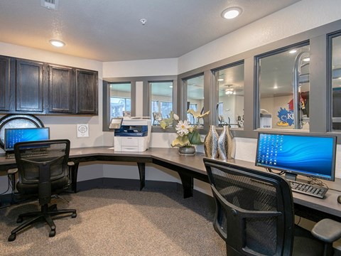 an office with two computer desks and a keyboard and monitor