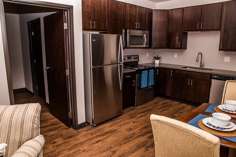 a kitchen with stainless steel appliances and a dining table
