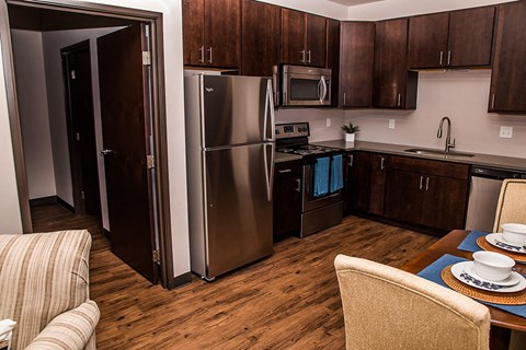 a kitchen with stainless steel appliances and a dining table