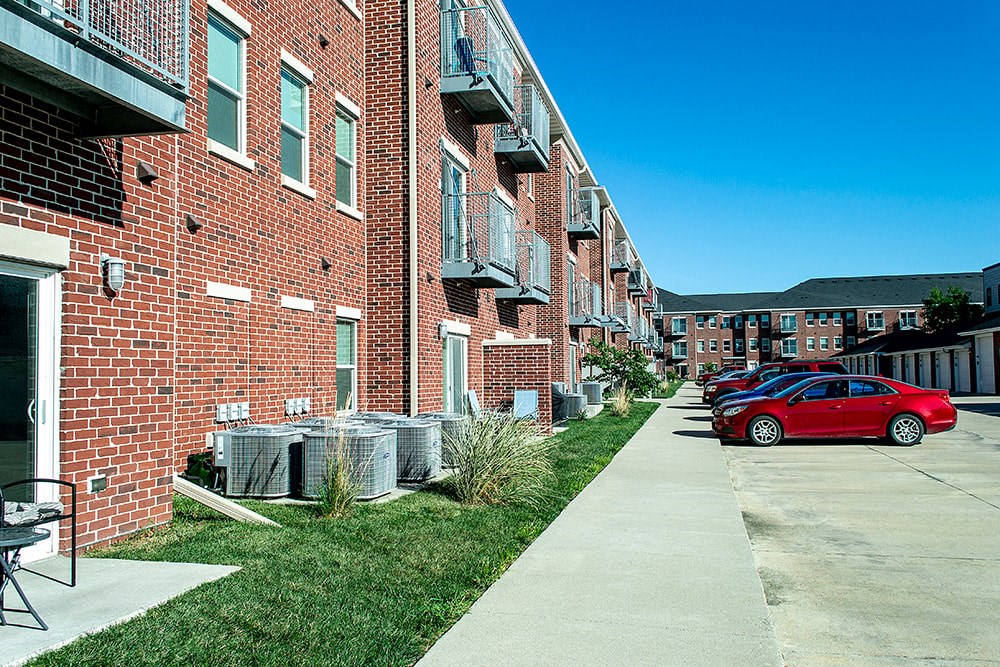 a red car parked in front of a brick building