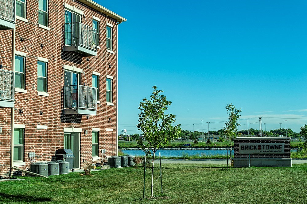 an apartment building with a river in the background