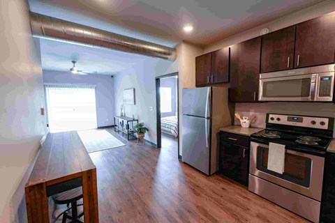 A kitchen with a stove, oven, and microwave.