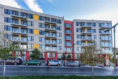 an exterior view of an apartment building on a city street