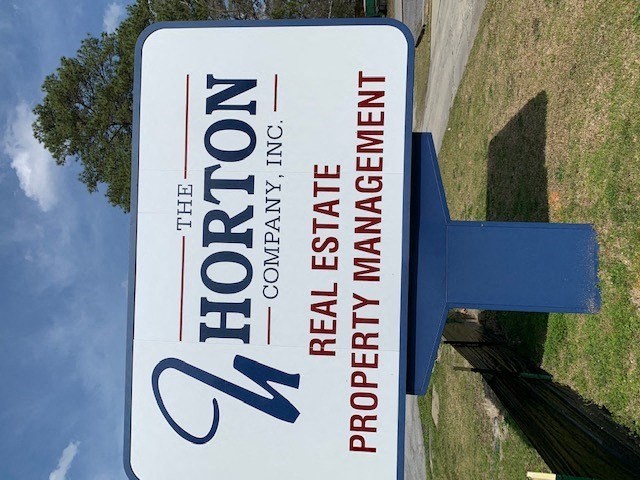 A sign for The Horton Company, Inc. Real Estate Property Management.