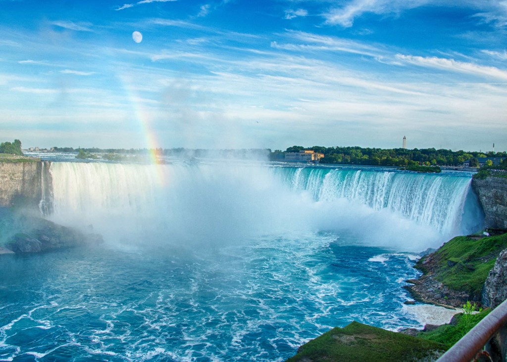 a rainbow in the sky falls and the waterfalls