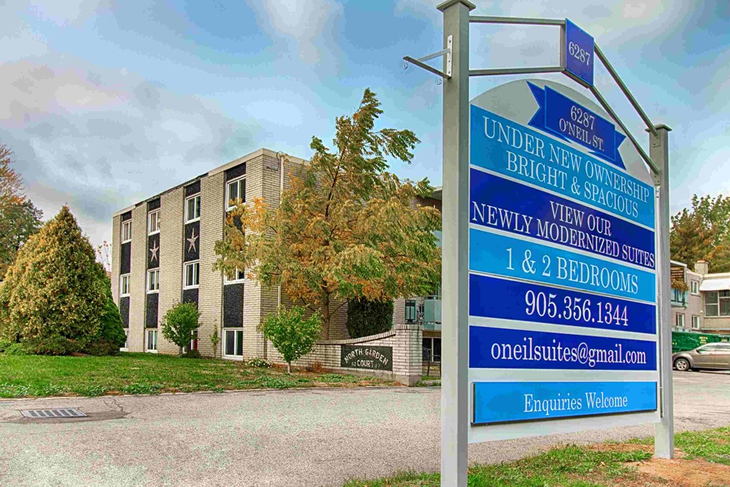 an image of an apartment building with a sign in front of it