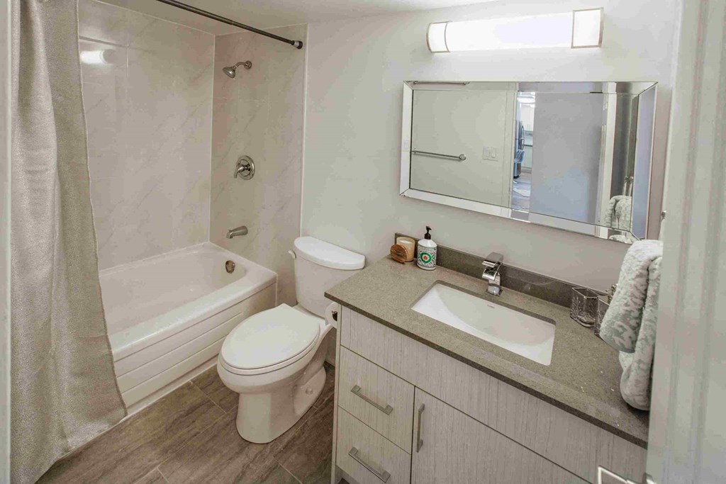 a bathroom with a sink toilet and a tub