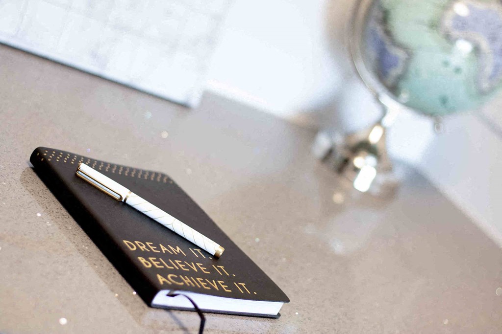 a commemorative pen sits on a desk next to a table