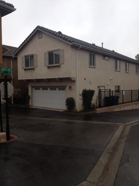 A house with a garage and a driveway in front.