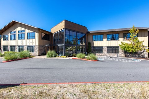A large building with a parking lot in front.