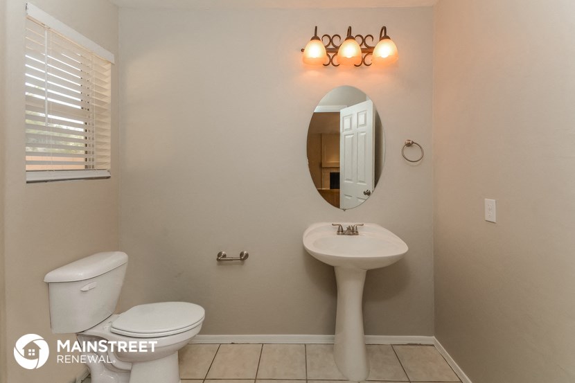 a bathroom with a sink and a toilet and a mirror