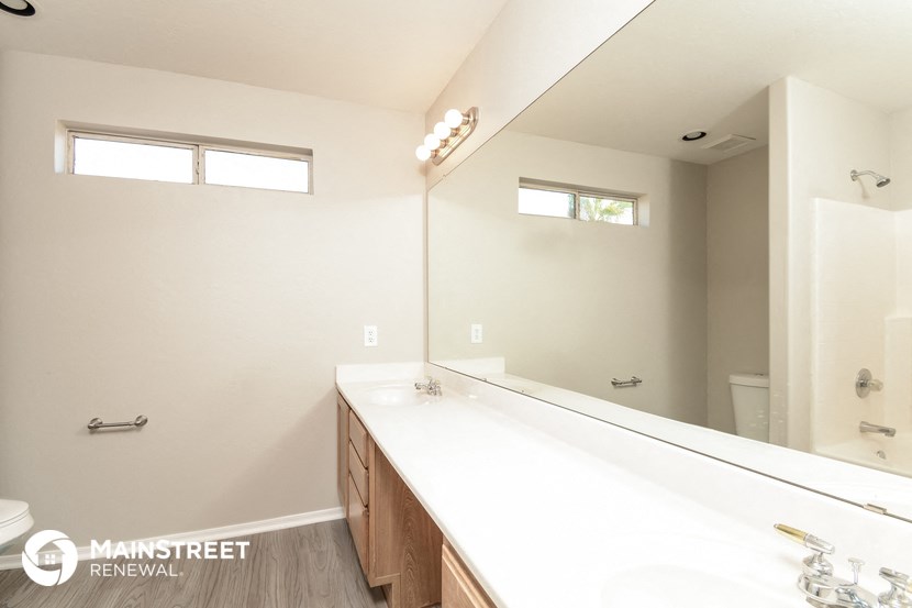 the master bathroom has a large mirror and a large sink