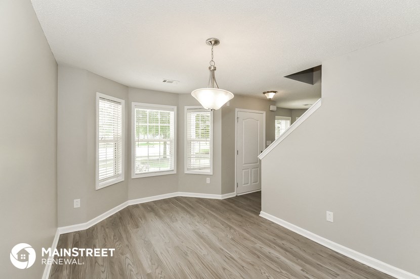 the living room and dining room of an apartment