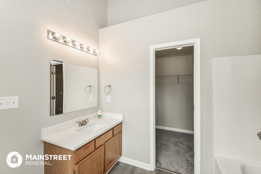 a bathroom with a sink and a mirror and a shower