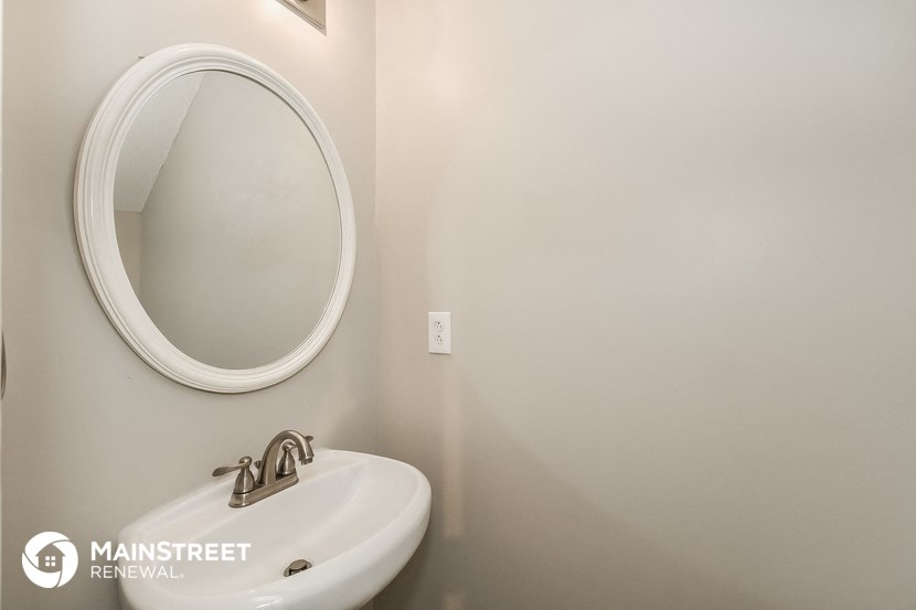 a small bathroom with a sink and a mirror