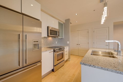 a kitchen with stainless steel appliances and granite counter tops