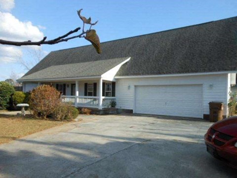 a house with a bird hanging from a tree
