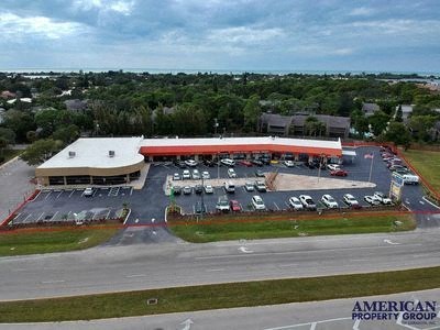 an aerial view of a parking lot with cars
