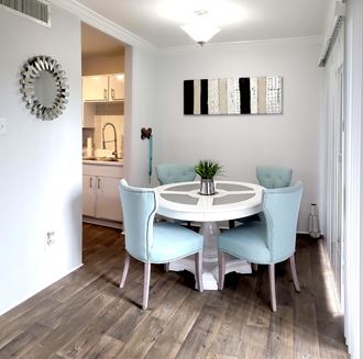 a dining room with a white table and blue chairs