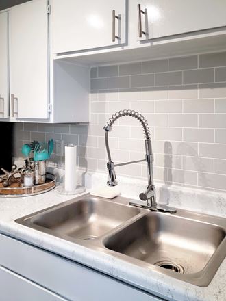 a kitchen sink with a faucet above it