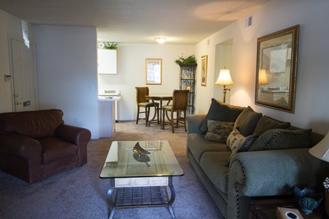 A living room with a couch, chair, and coffee table.