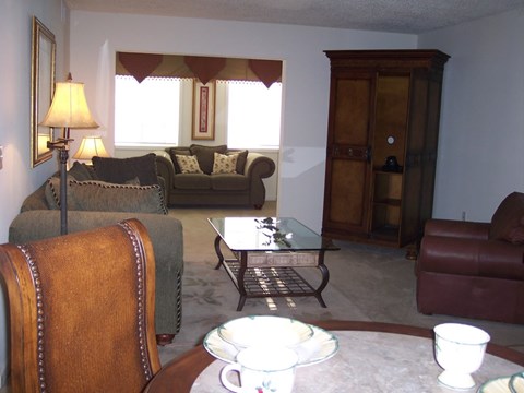A living room with a couch, chair, and coffee table.