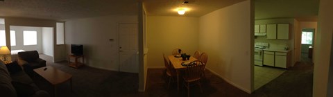 A living room with a couch and a television.