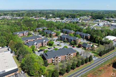 A bird's eye view of a residential area with houses and a road.
