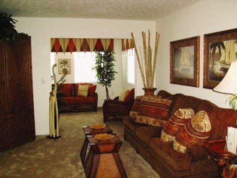 A living room with a couch, chair, and decorative items.