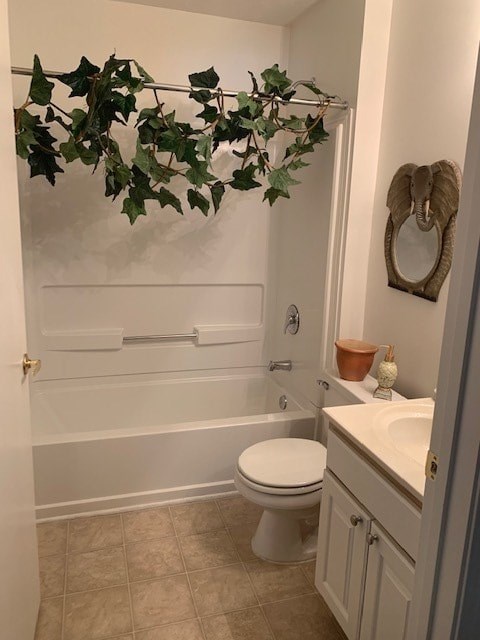 A bathroom with a toilet, sink, and a plant hanging from the ceiling.