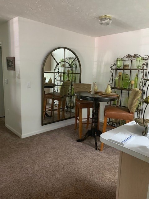 A dining room with a table and chairs.