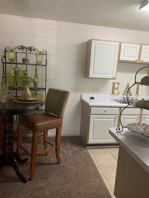 A kitchen with a table and chairs.