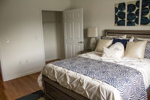 A bedroom with a bed and a lamp.
