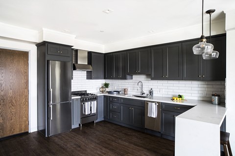 A modern kitchen with dark wood cabinets and a white island.