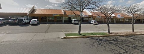 A parking lot with a building in the background.
