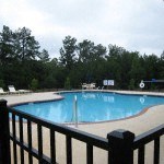 a large swimming pool with a fence around it