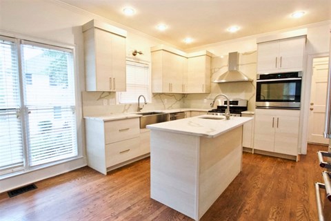 a kitchen with white cabinets and a white counter top