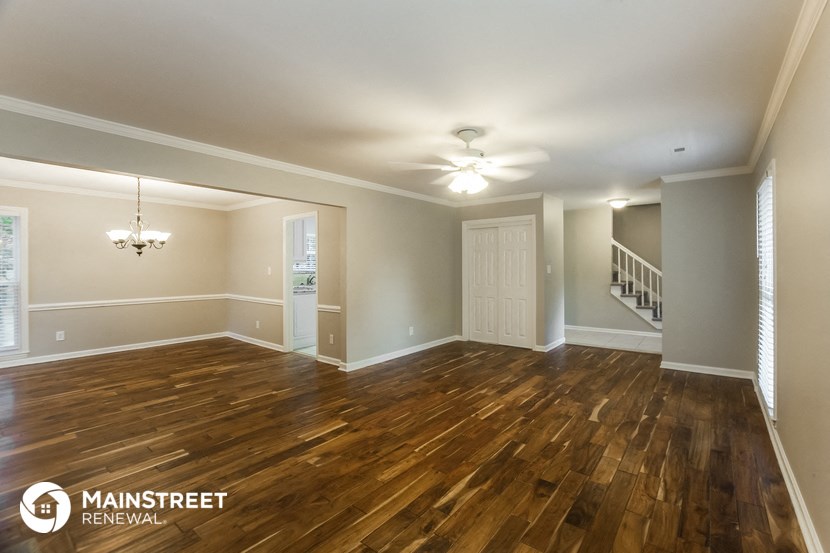 the living room and dining room with hardwood flooring